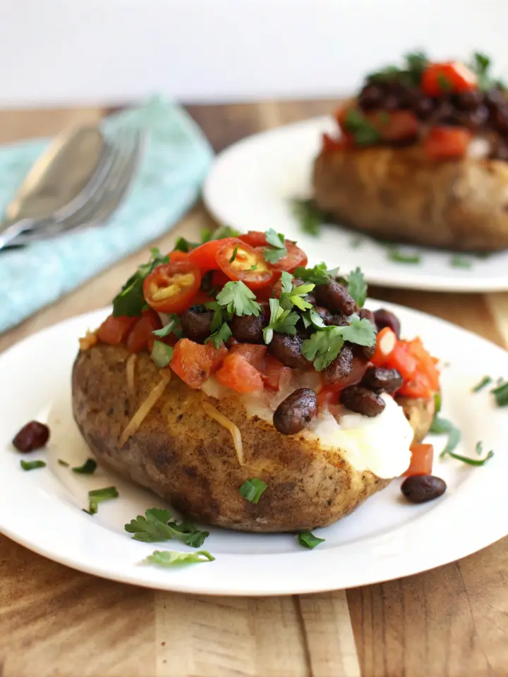 Perfectly baked potato in oven with crispy skin and fluffy interior.